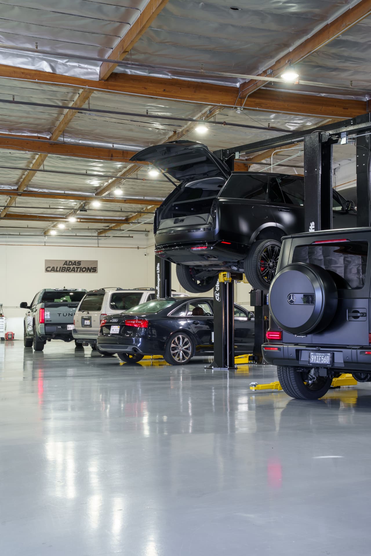 ADAS calibration bay at PC Automotive with vehicles on lifts