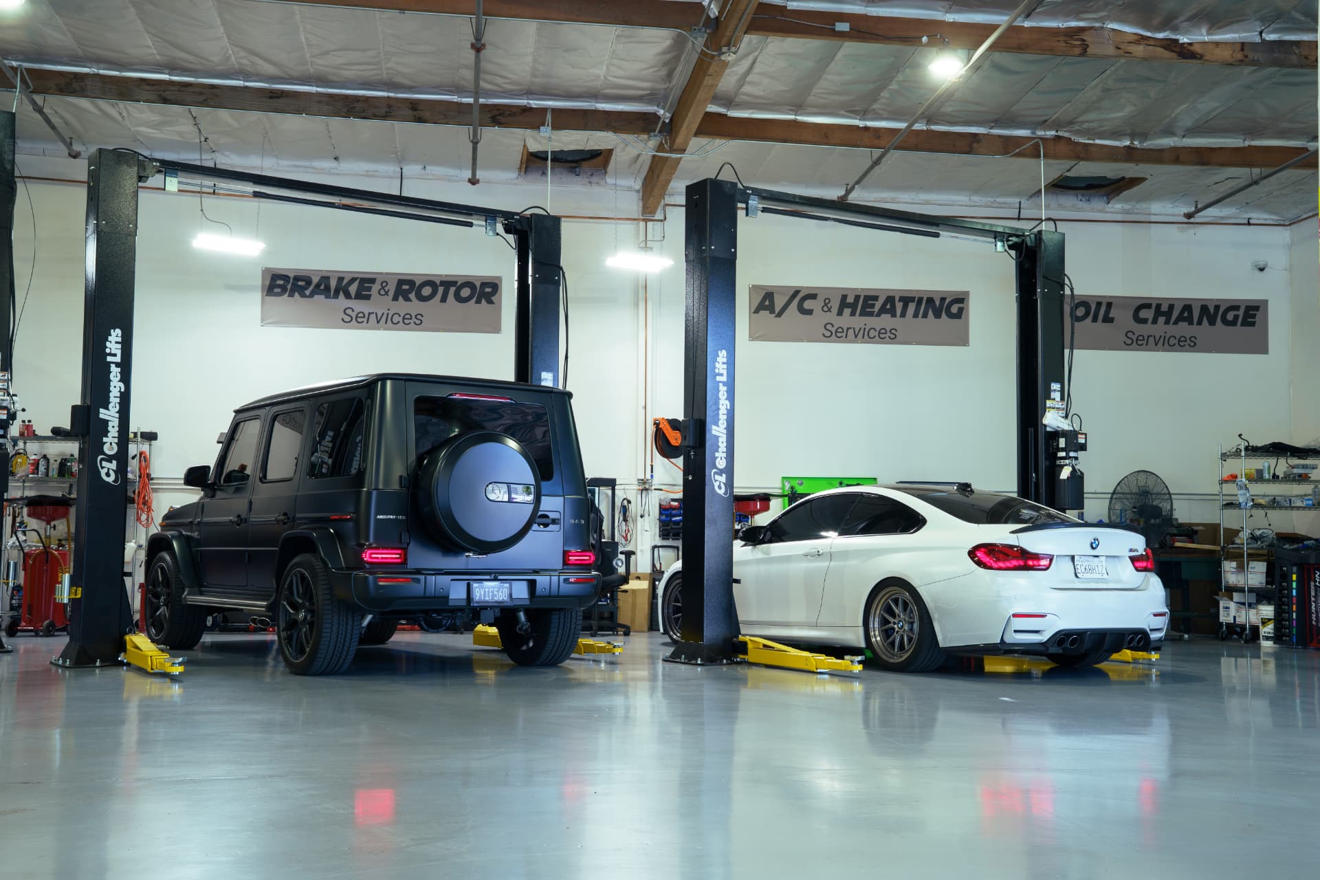 Vehicles on Challenger lifts in the brake, A/C and oil change bays