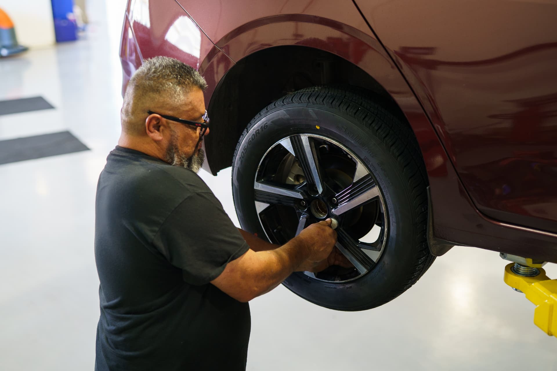 Technician removing a wheel during a tire service