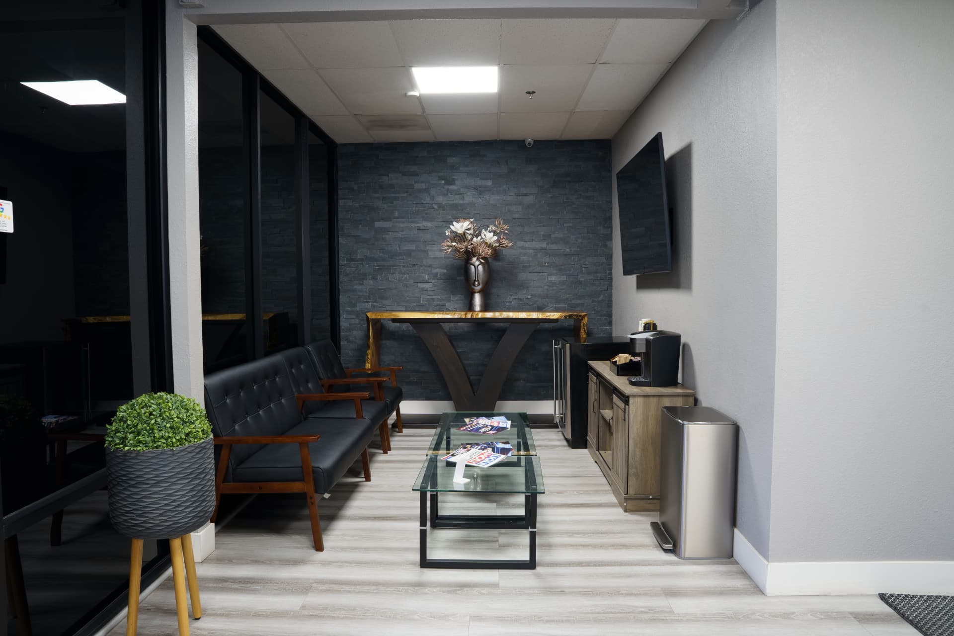 Customer waiting lounge with seating, TV and complimentary coffee