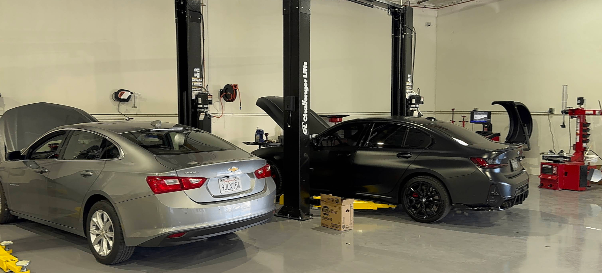 Vehicles on Challenger lifts in service bays